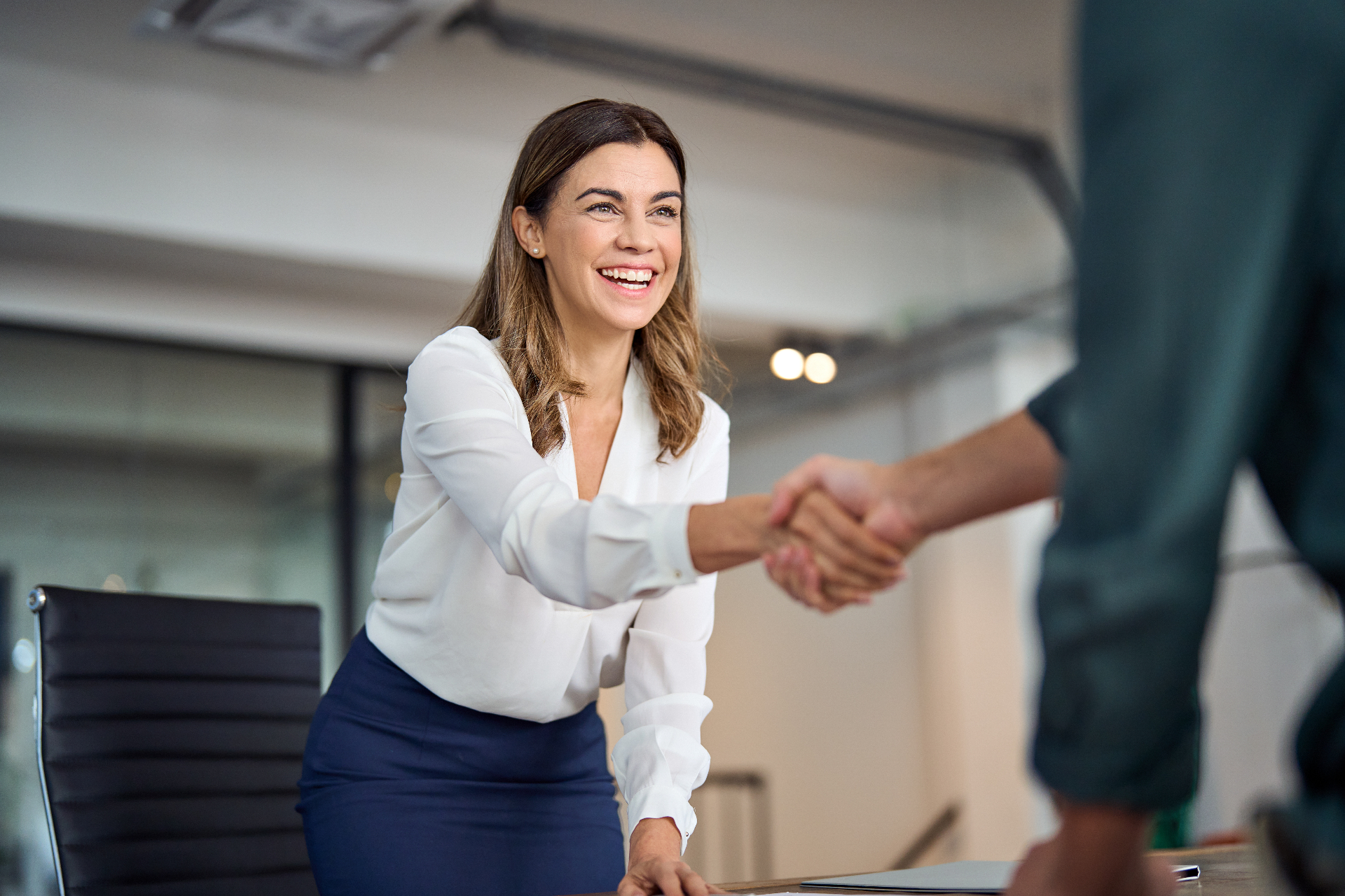 Business leaders shaking hands during a professional partnership meeting