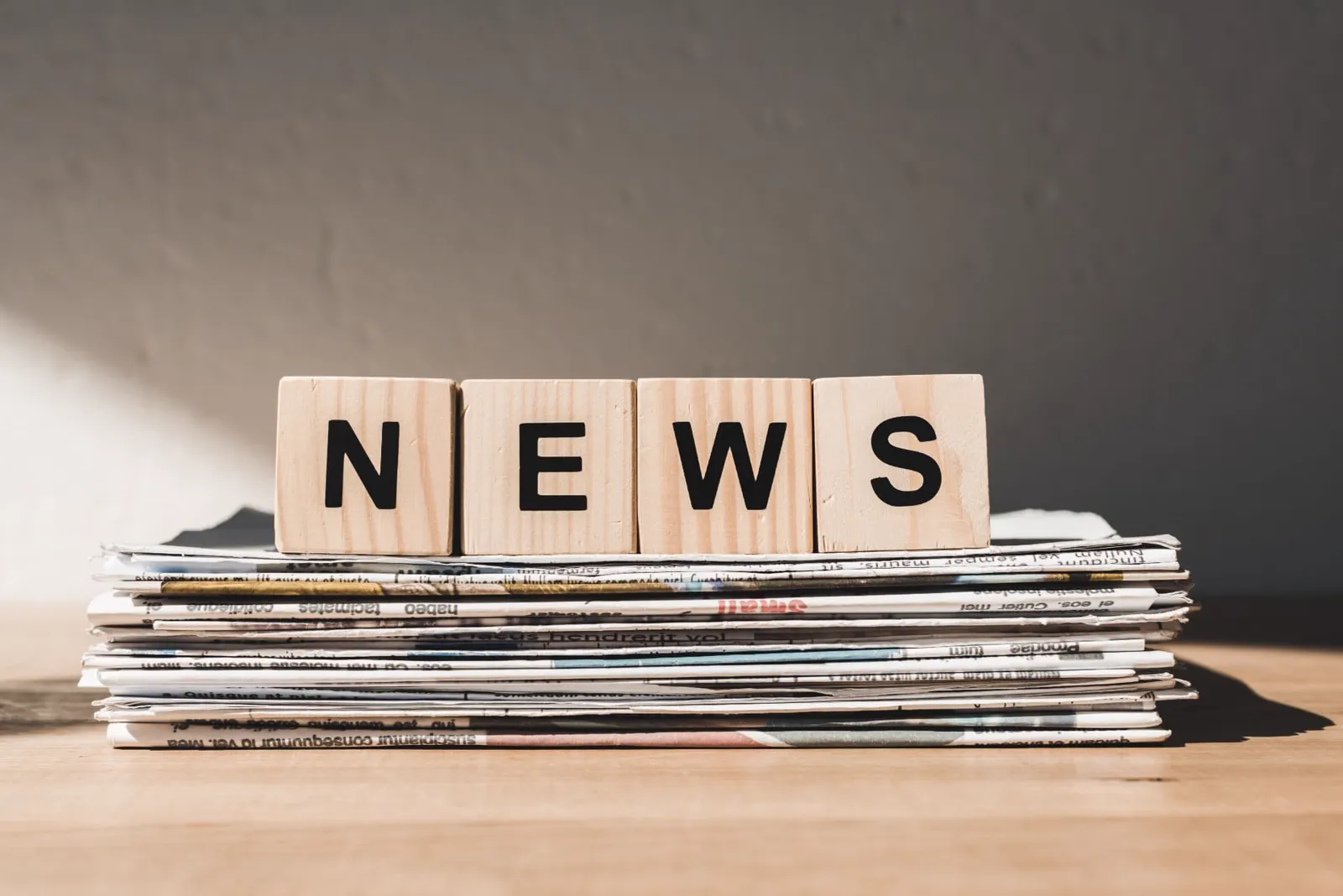 Newspapers stacked on a desk, representing UKFOS editorial news coverage