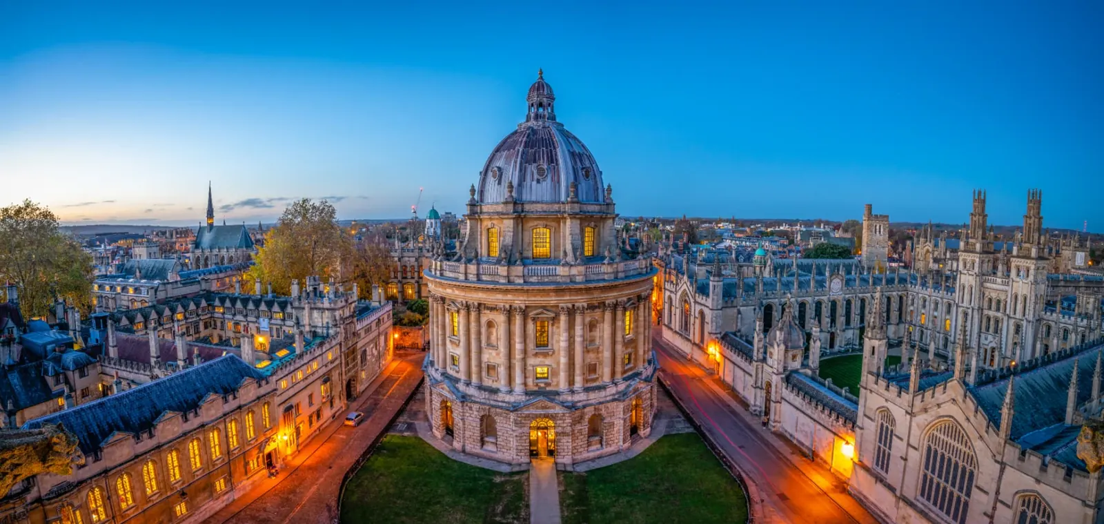 Aerial view of central Oxford at dusk, including the Radcliffe Camera and surrounding college rooftops