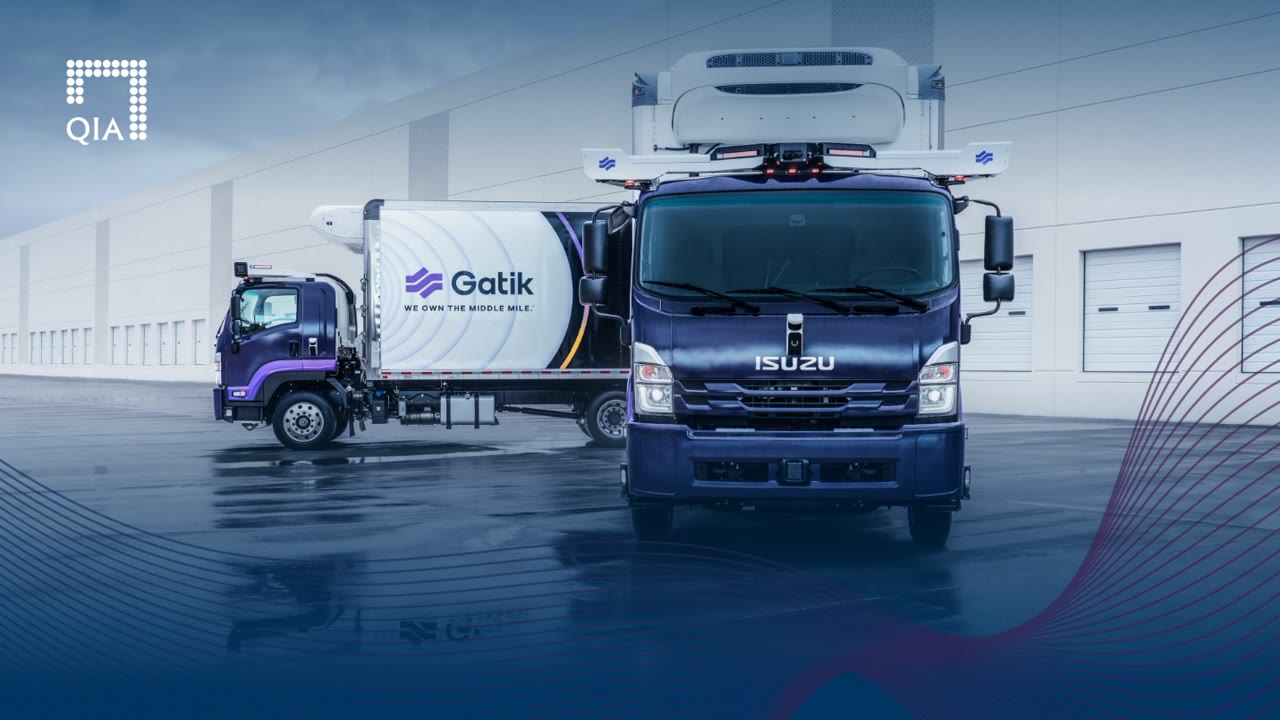 Gatik autonomous freight trucks parked at a distribution centre loading area